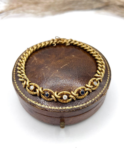 A sapphire and diamond fancy curb link bracelet in yellow gold