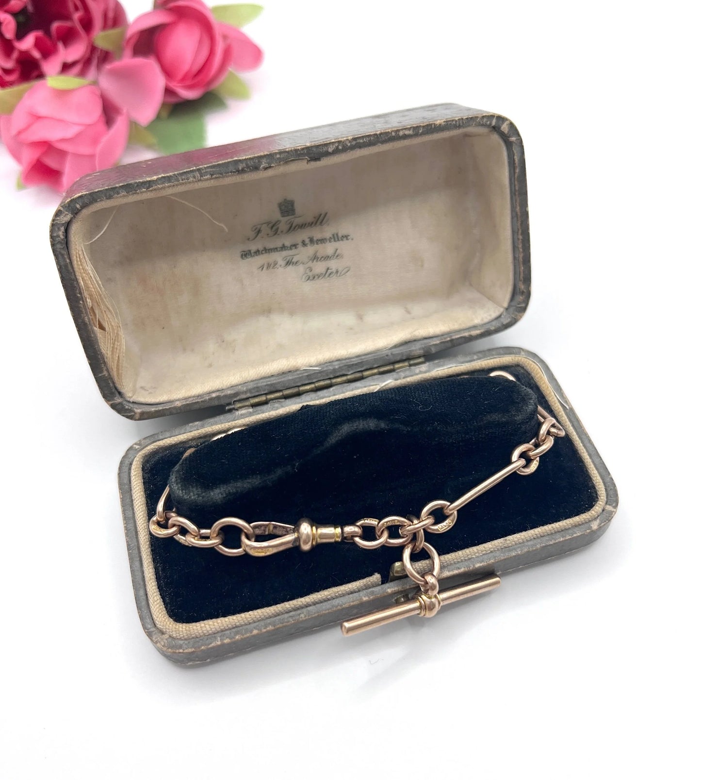 A rose gold link bracelet with a T-bar, in an antique box