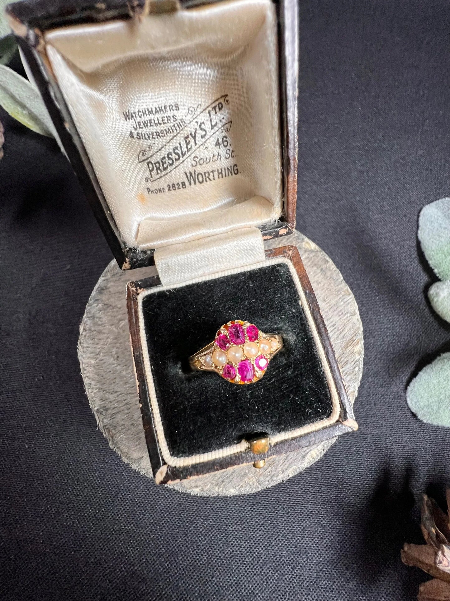 A yellow gold ruby and pearl cluster ring, in a ring box