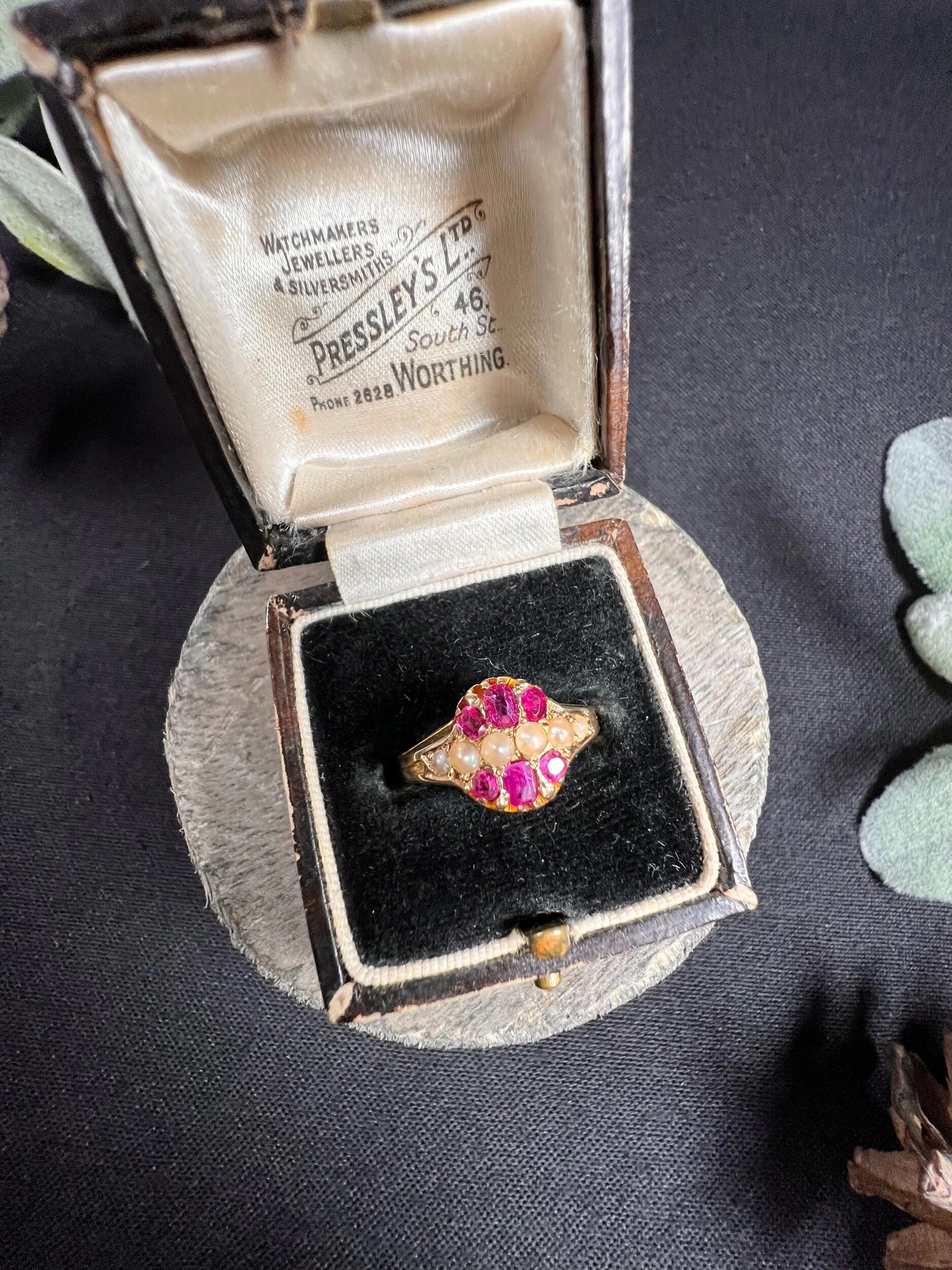 A yellow gold ruby and pearl cluster ring, in a ring box