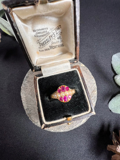 A yellow gold ruby and pearl cluster ring, in a ring box