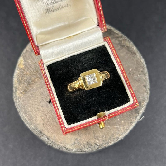 A yellow gold solitaire princess cut diamond ring, in an antique ring box