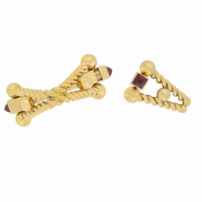 A pair of yellow gold ruby cufflinks, on a white background