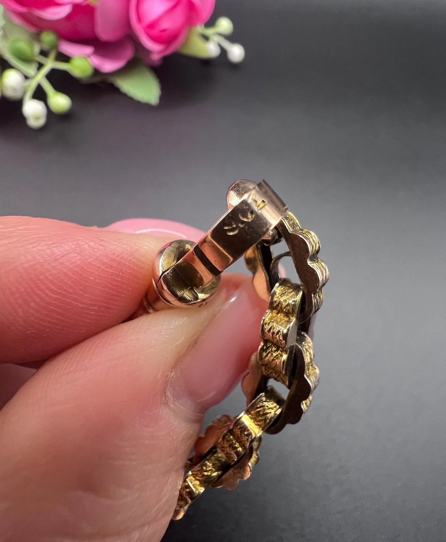 Close-up of 9CT stamp on a yellow gold bracelet clasp