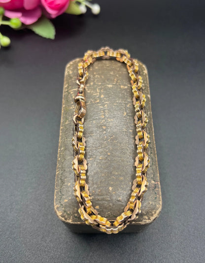 A fancy link yellow gold bracelet with a lobster claw clasp