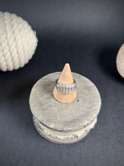 A three row diamond band ring in platinum on a ring cone