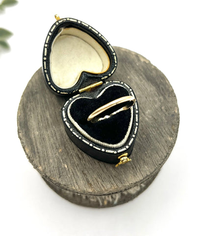 A yellow gold ring in a heart-shaped ring box