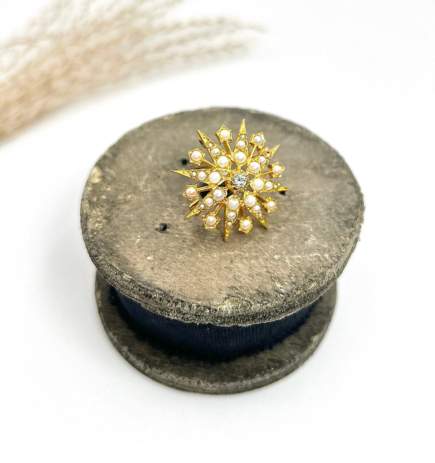 A star-shaped pearl and diamond brooch/pendant in yellow gold