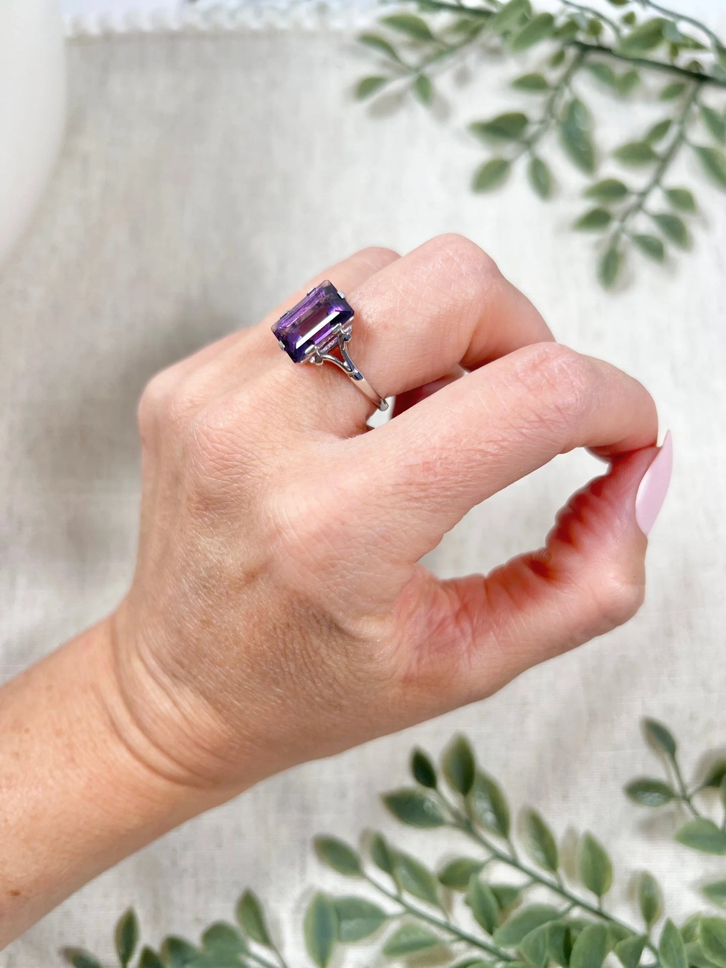 A solitaire amethyst cocktail ring in platinum, modelled on a hand