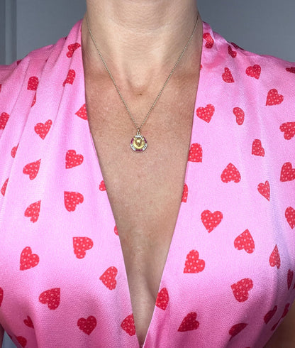 A fox head pendant in yellow gold with a ruby and diamond border, modelled with a gold chain