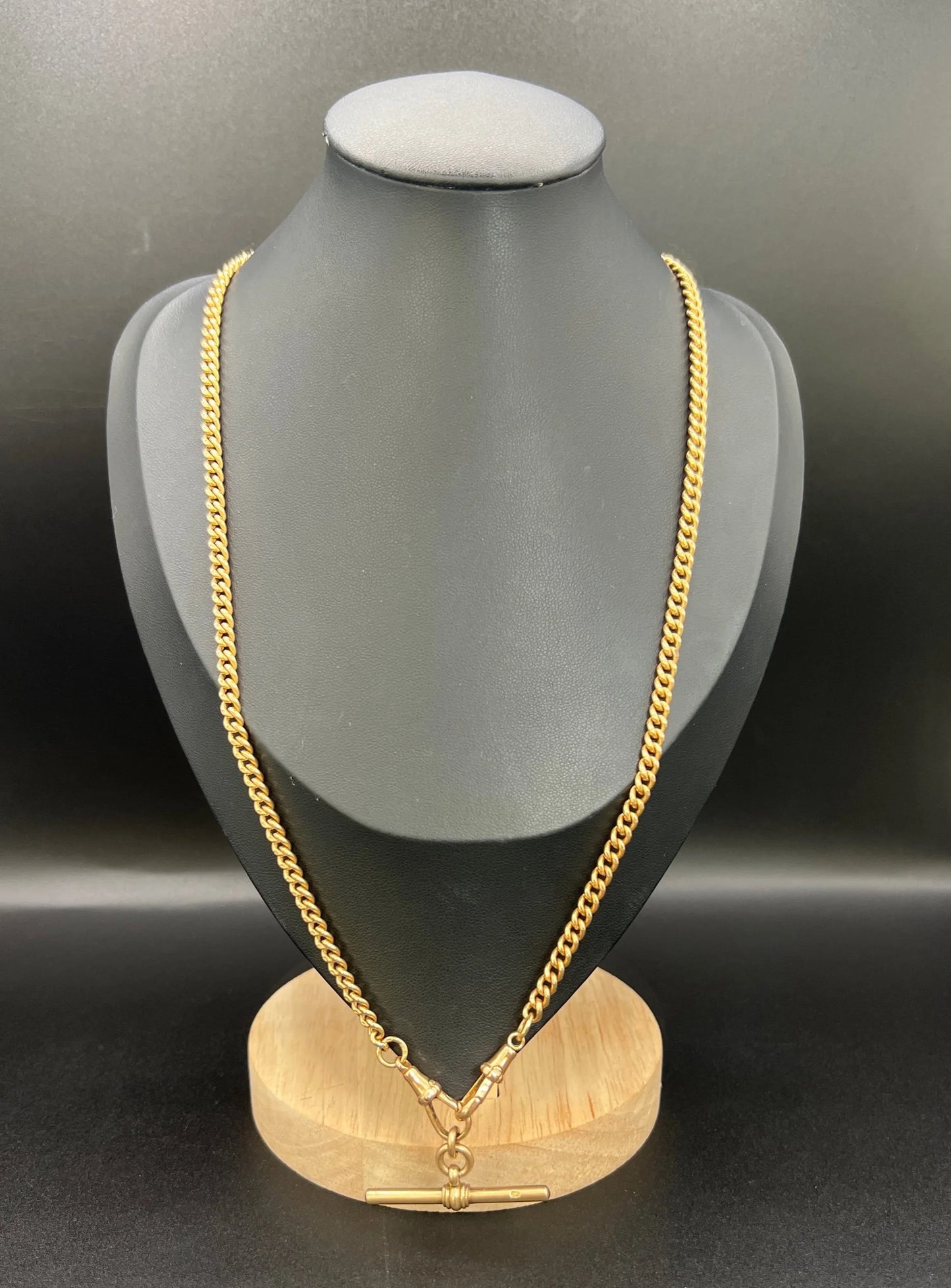 A gold curb link Albert chain, modelled on a black jewellery bust