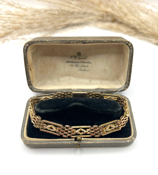 A yellow gold gate bracelet, in an antique box