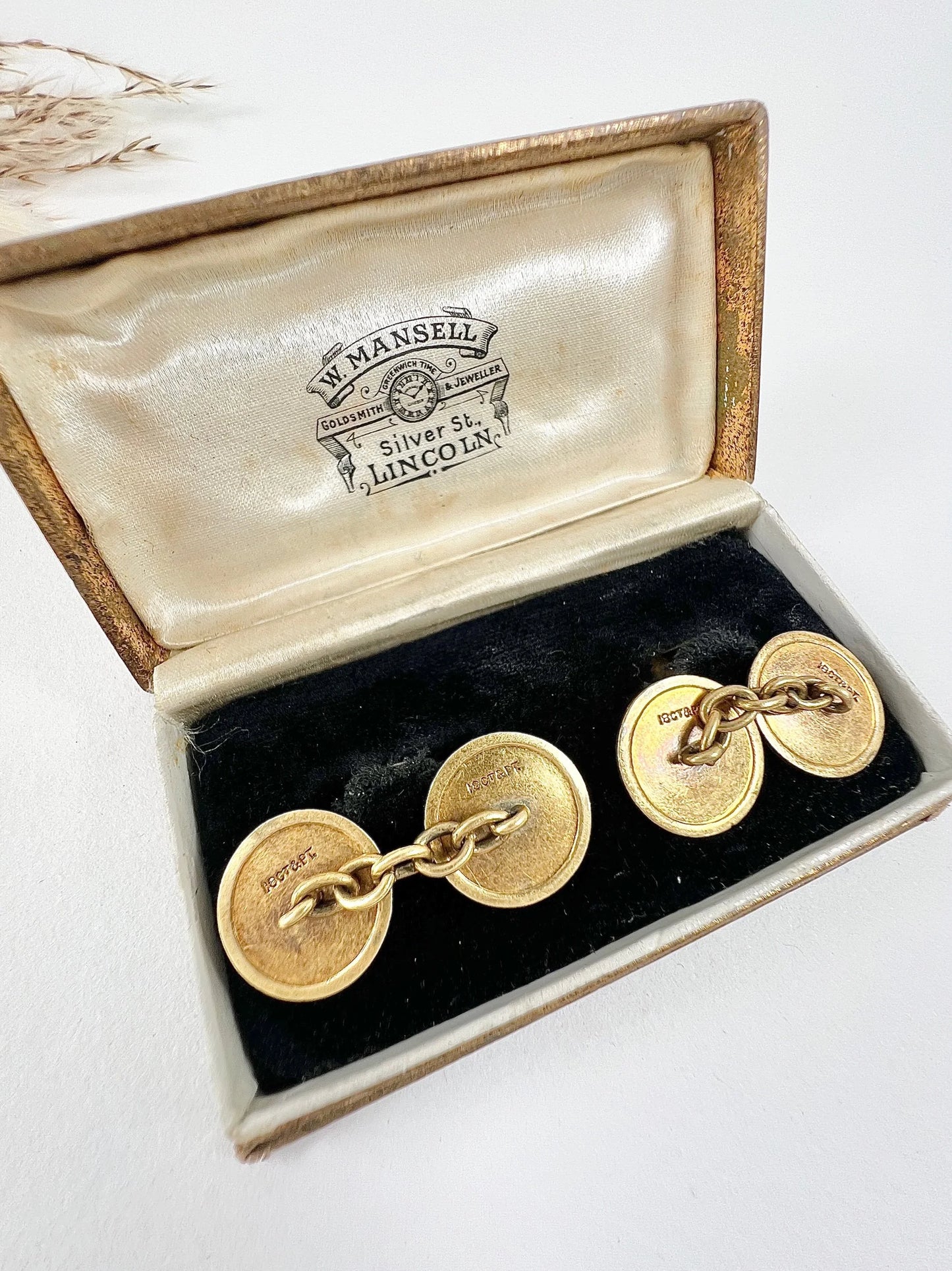 A pair of circular platinum and yellow gold cufflinks, in an antique box