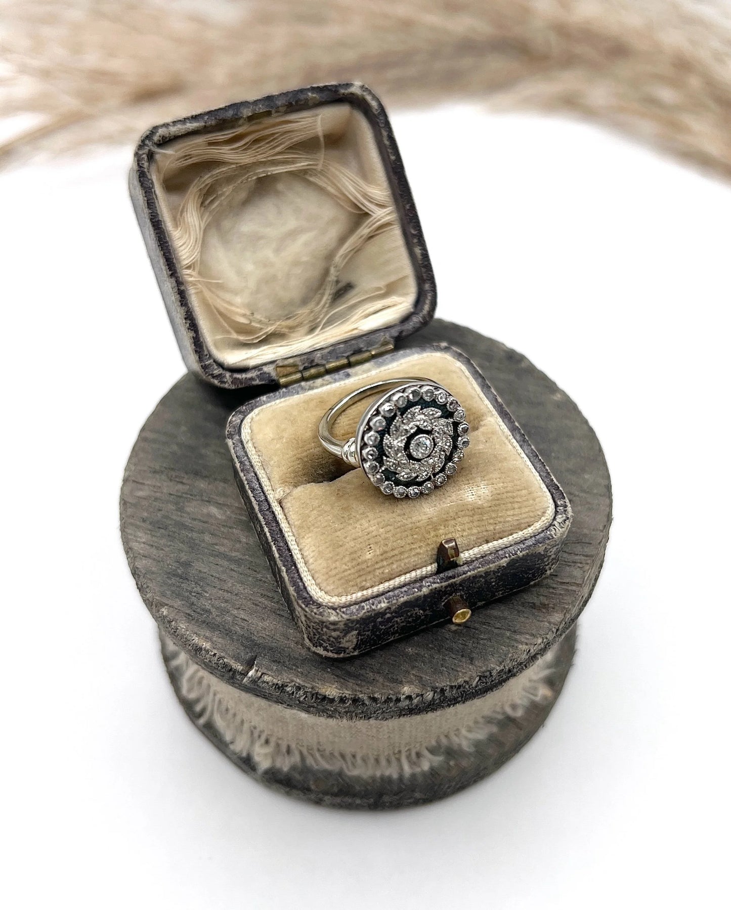 A diamond and dark blue enamel fancy cluster ring in white gold, in a ring box