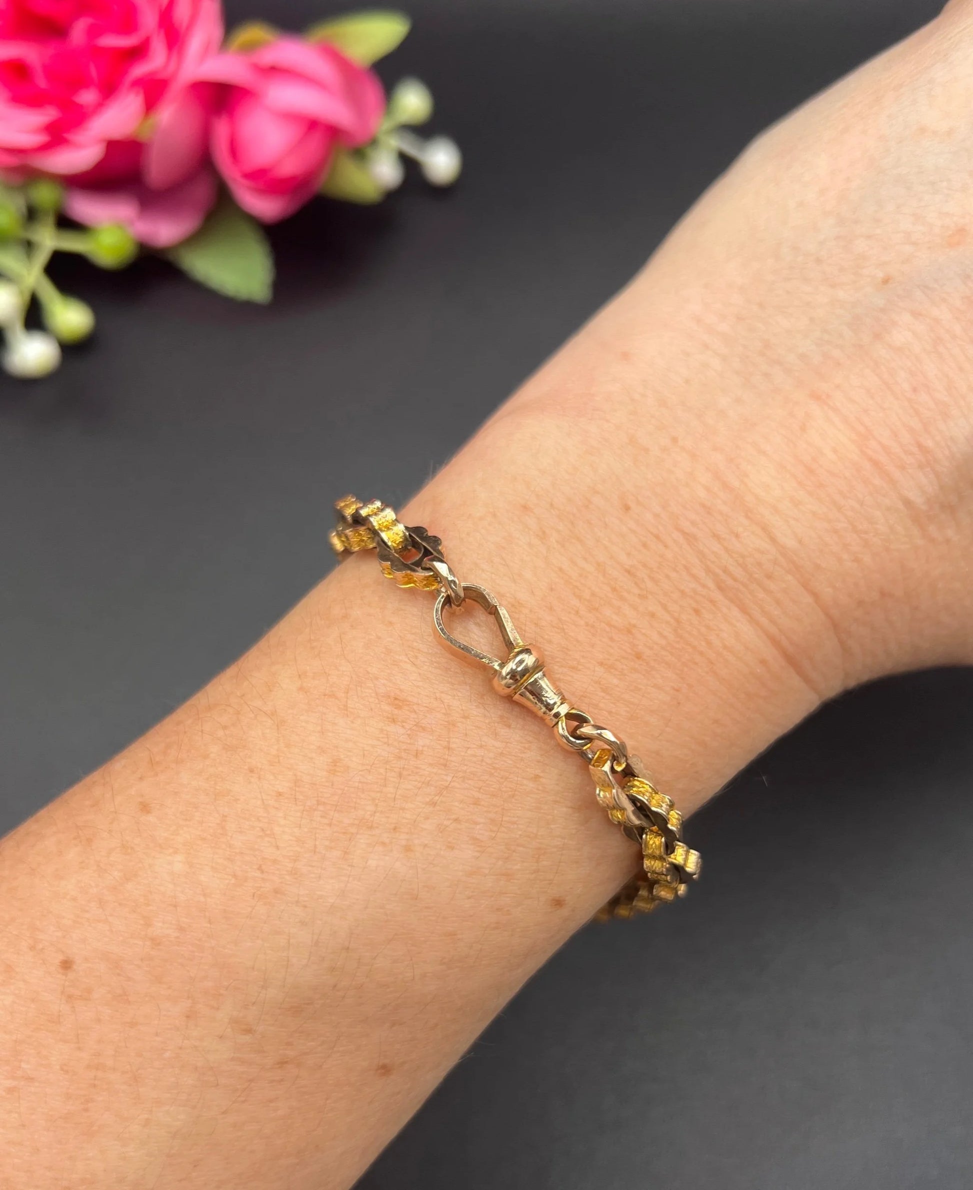 A fancy link yellow gold bracelet with a lobster claw clasp, modelled on a wrist