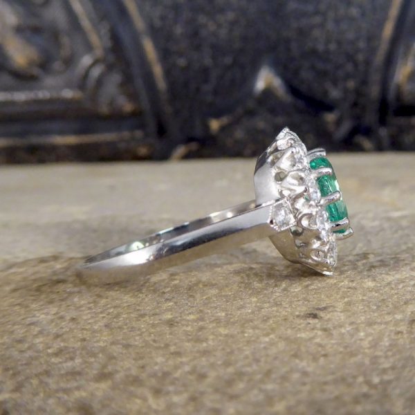 Contemporary 1ct Emerald and 0.95ct Diamond Cluster Ring