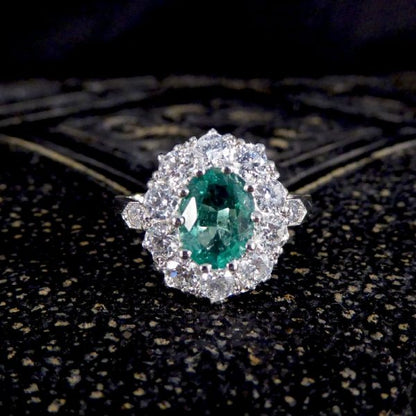 Contemporary 1ct Emerald and 0.95ct Diamond Cluster Ring