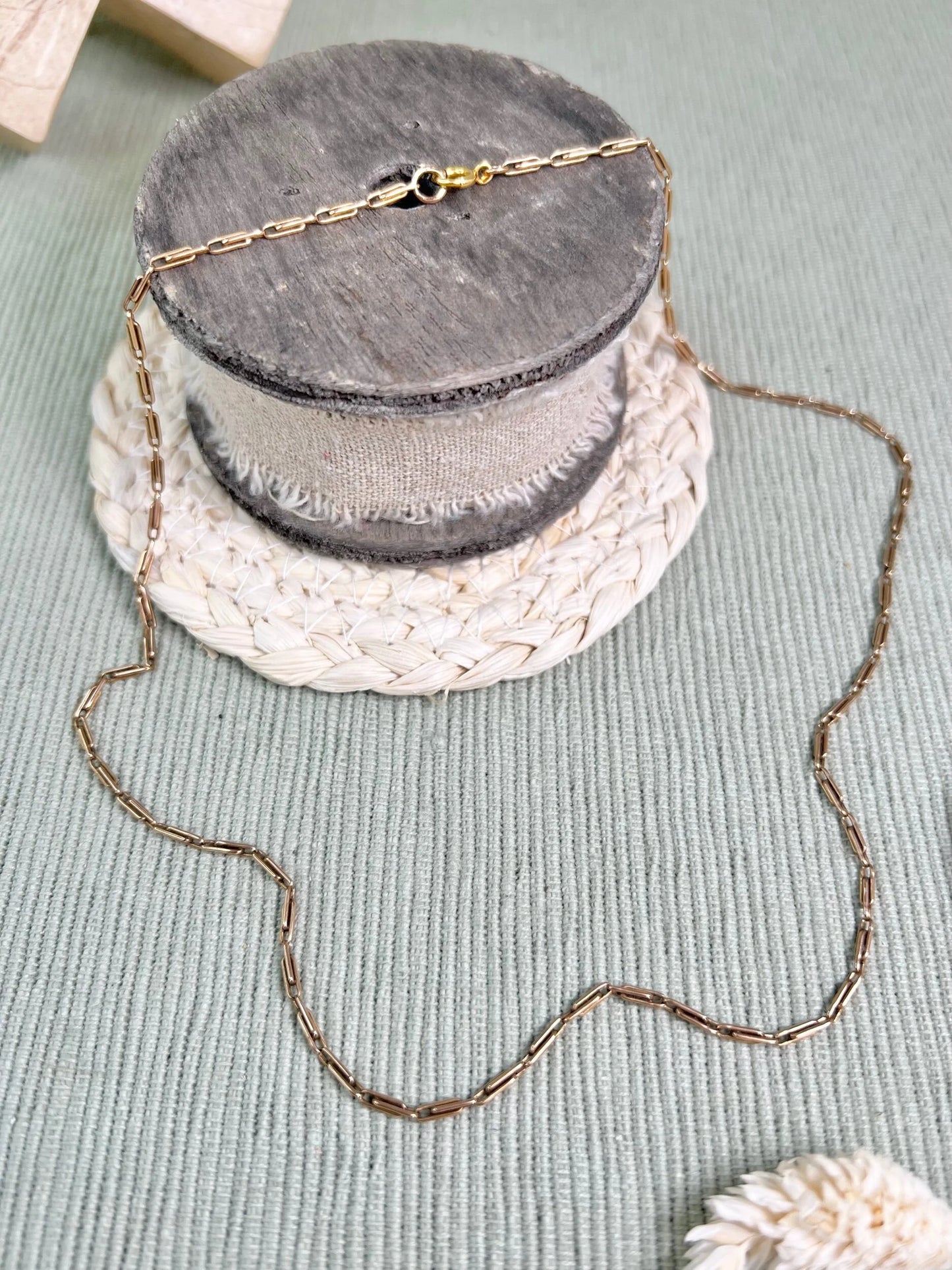 A gold paperclip link chain necklace