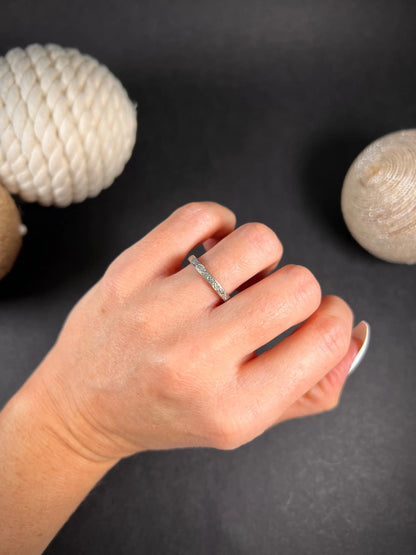 A full eternity ring in white gold, set with diamonds, modelled on a hand