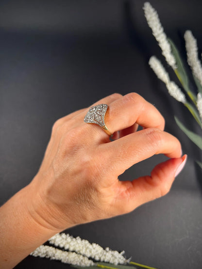 A diamond cocktail ring in yellow and white metal modelled on a hand