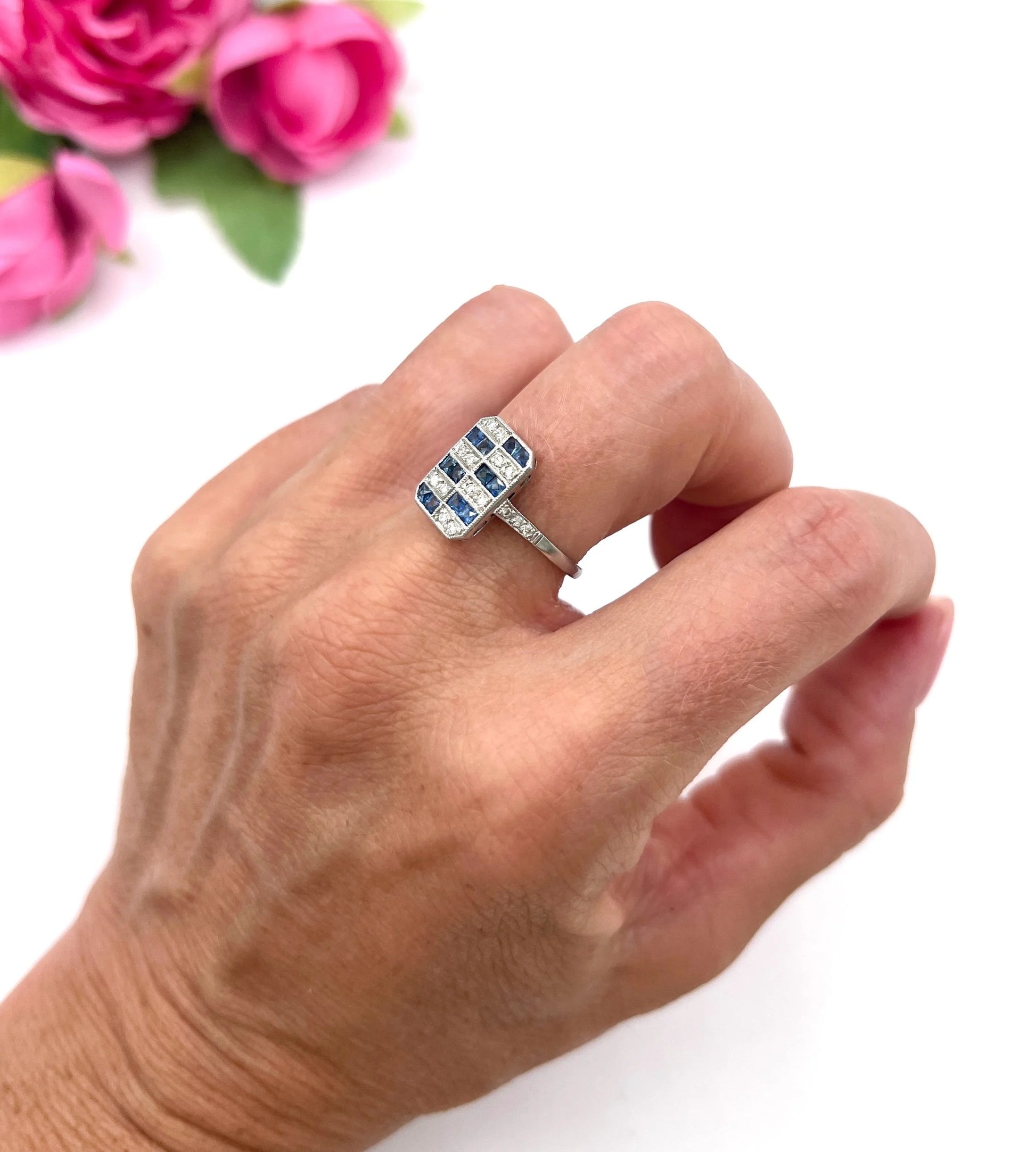 A sapphire and diamond tablet style ring in platinum, modelled on a hand