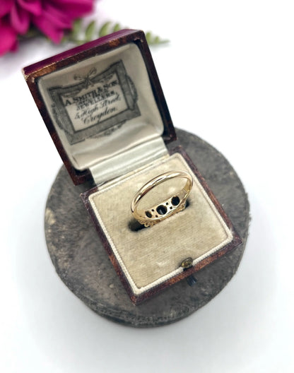 A seven stone sapphire and diamond carved ring in yellow gold, in a ring box