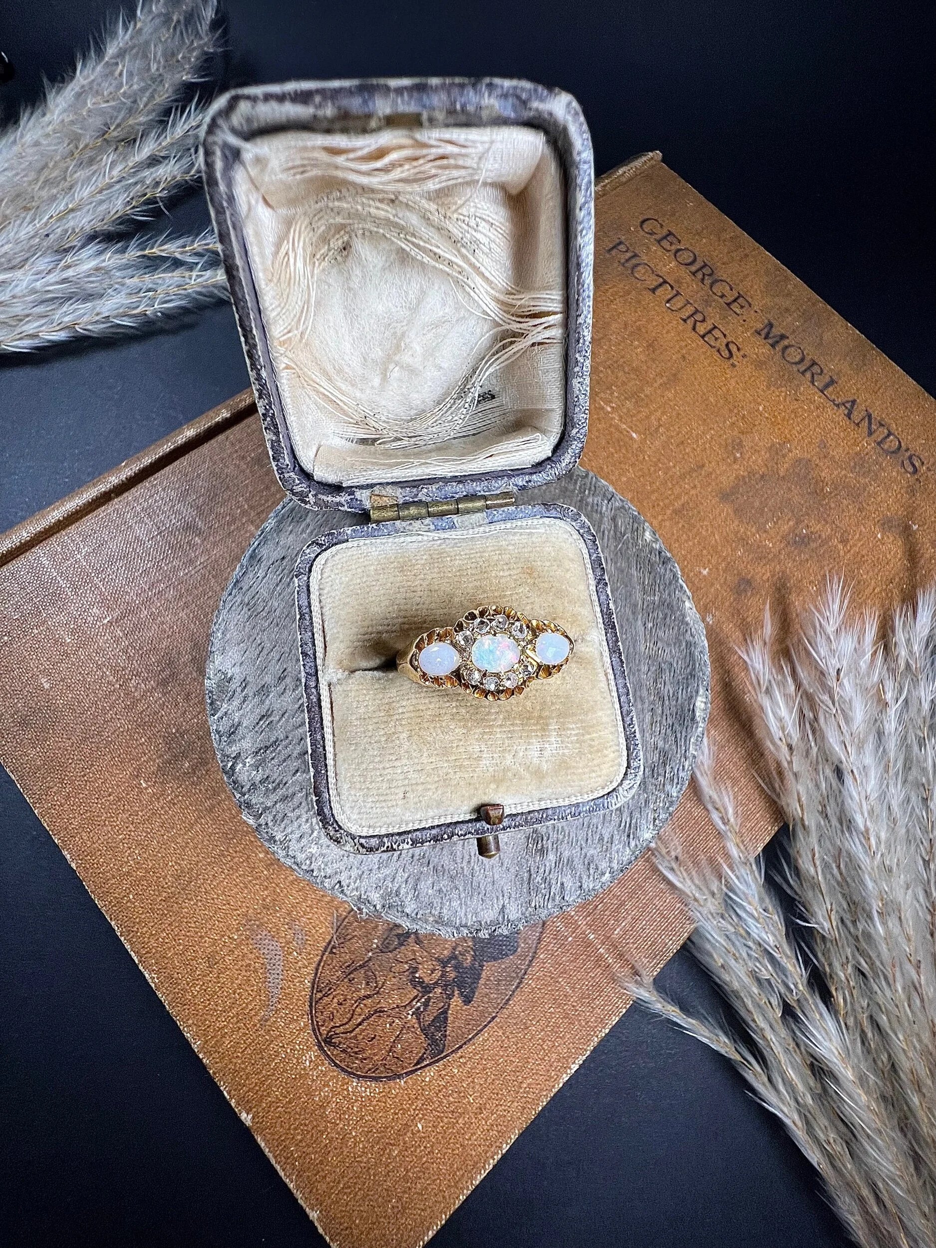 A yellow gold opal and diamond dress ring, in a ring box