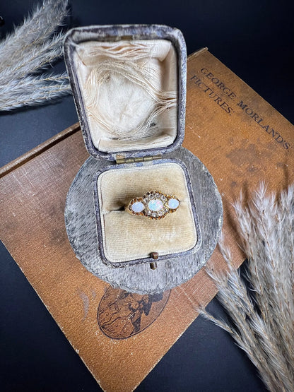 A yellow gold opal and diamond dress ring, in a ring box