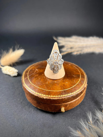 A diamond cocktail ring in white metal, on a ring cone