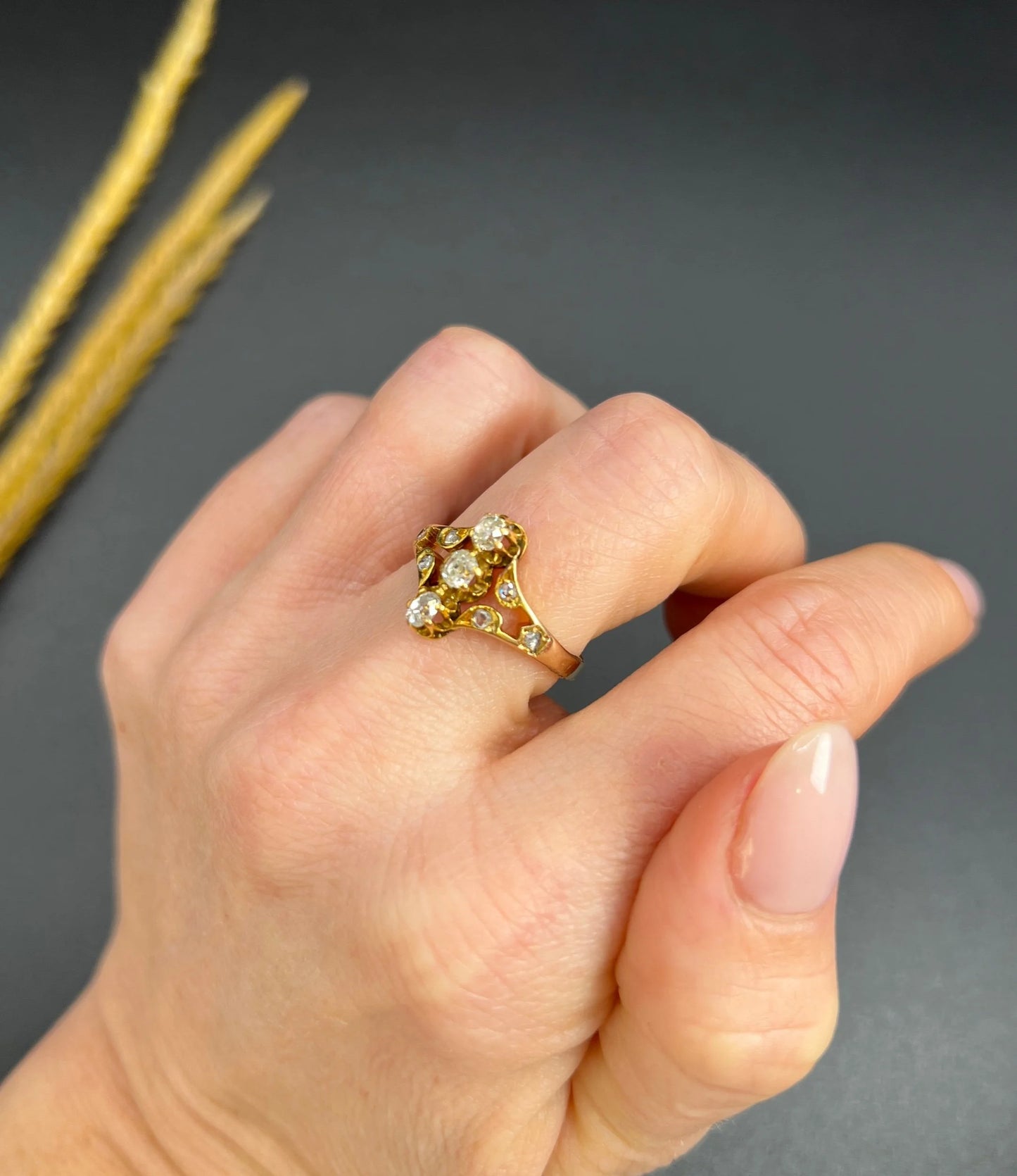 An antique old cut diamond ring in yellow gold, modelled on a hand