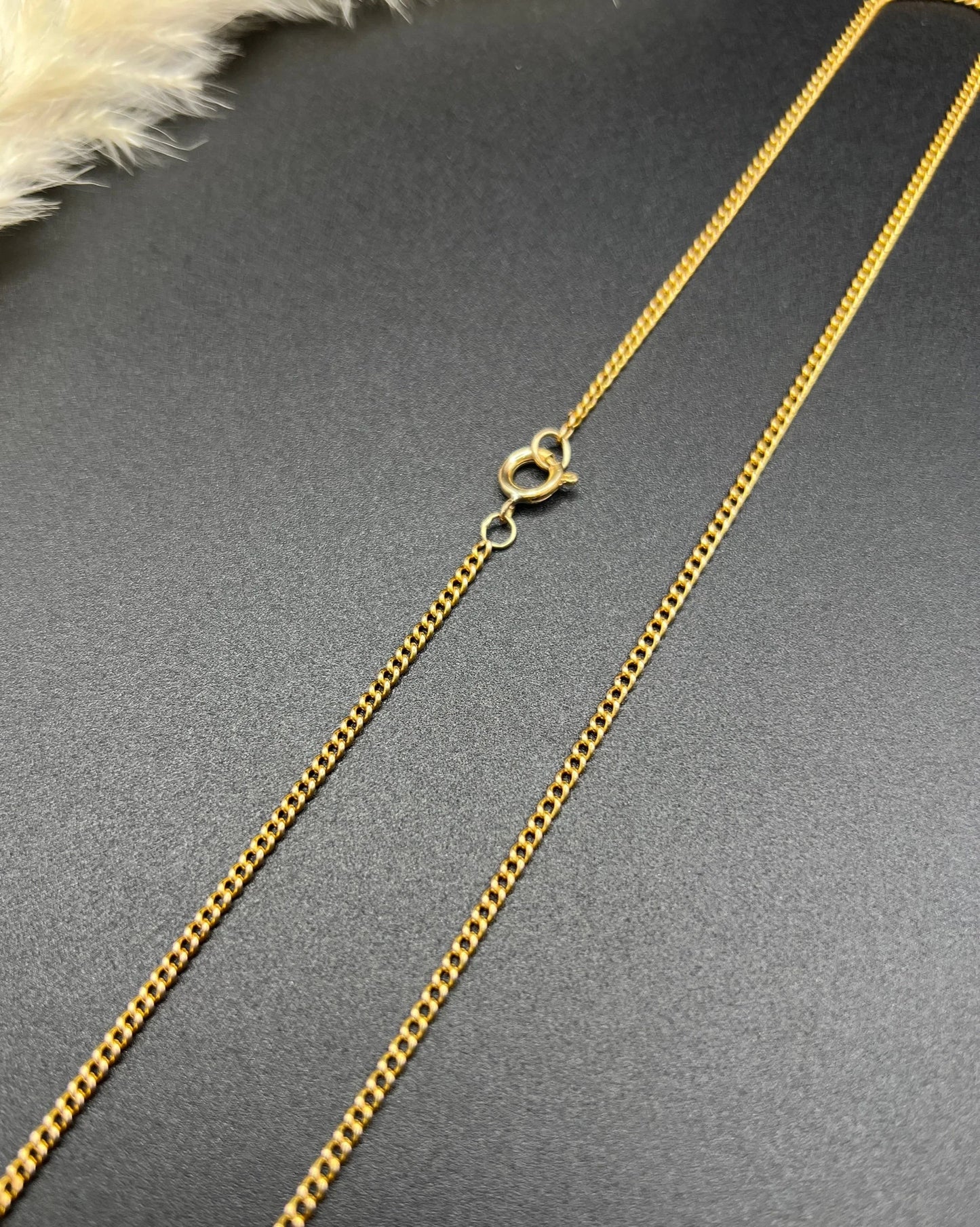 A fine curb link chain necklace in yellow gold