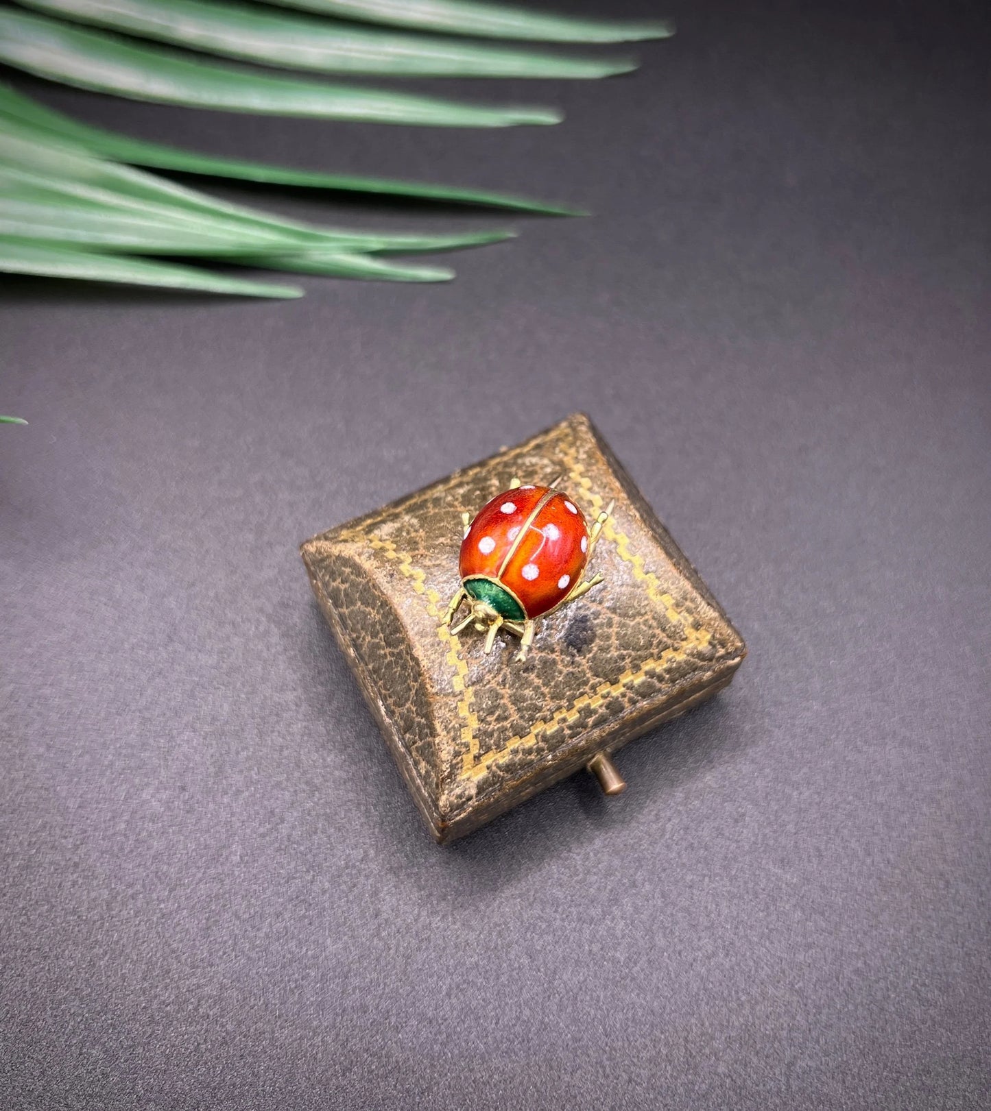 A yellow gold and enamel ladybird brooch