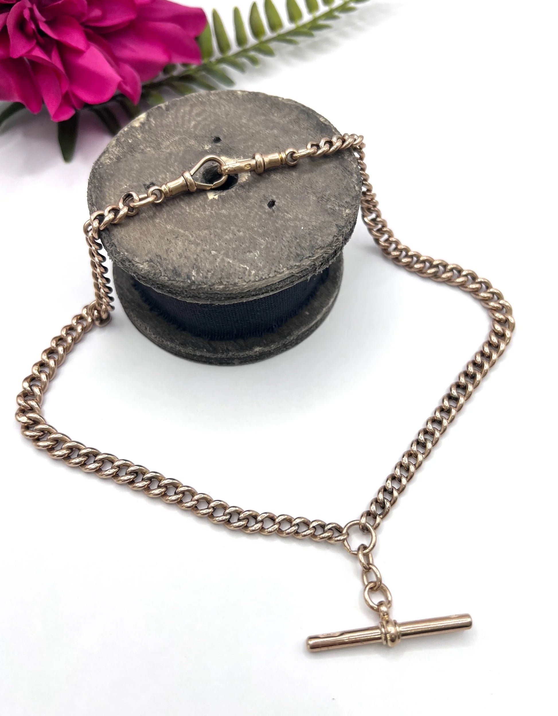 A rose gold curb link Albert chain with t-bar