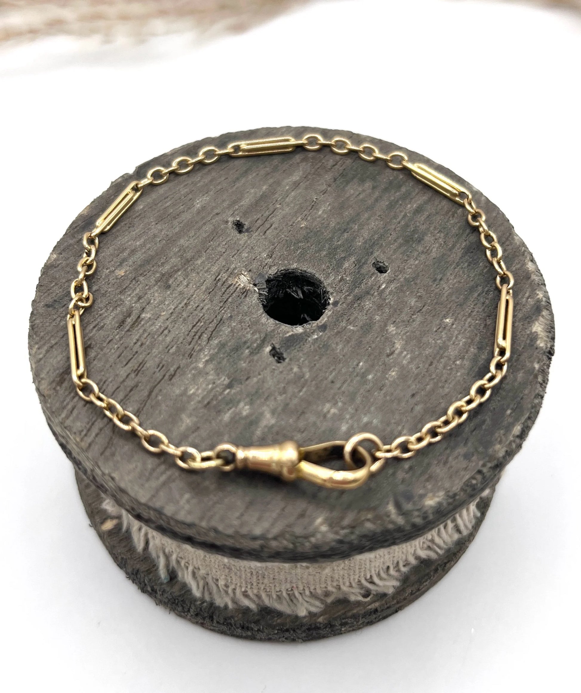A yellow gold link bracelet with a lobster claw clasp