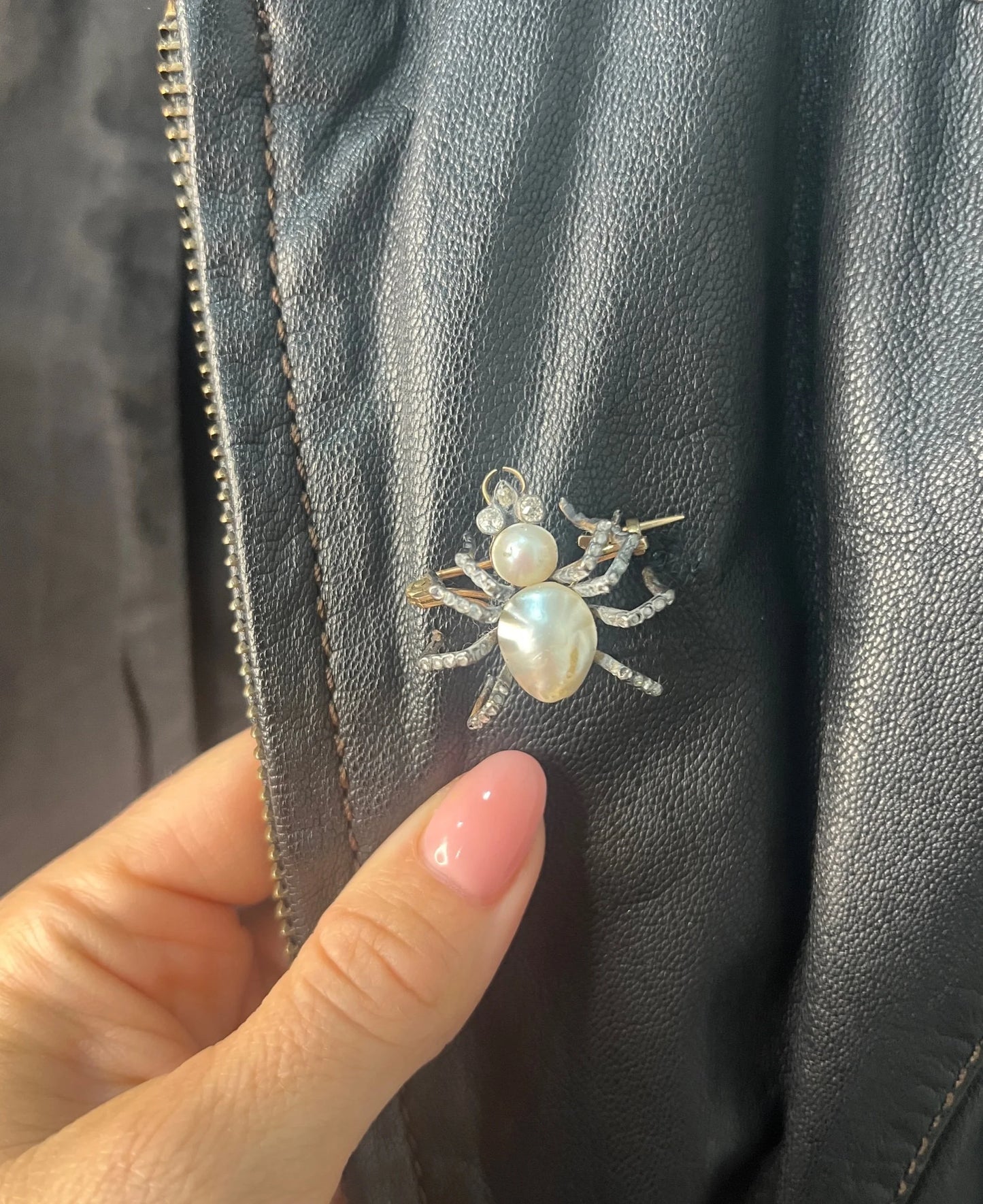 A pearl and diamond spider brooch in gold and silver, modelled on a black leather jacket