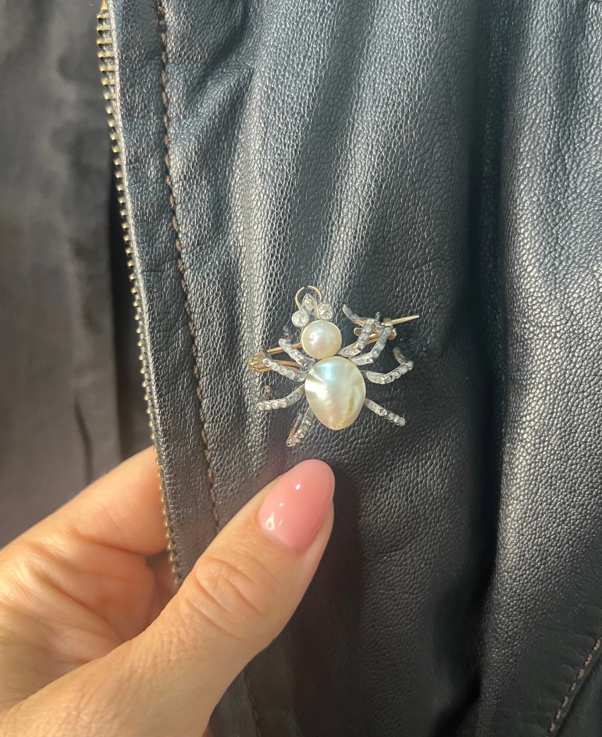 A pearl and diamond spider brooch in gold and silver, modelled on a black leather jacket