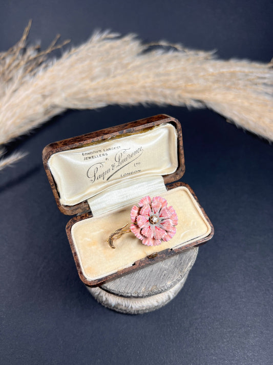 A pink enamelled flower brooch with a diamond centre, in yellow gold, in a box
