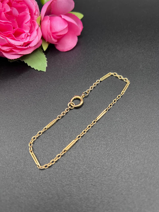 A yellow gold chain link bracelet with a bolt ring clasp