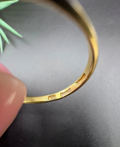 Stamps inside a yellow gold ring shank
