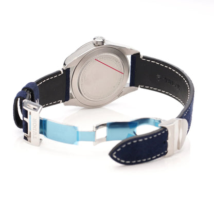 Tudor Geneve Chronometer wristwatch with navy blue dial, bezel and strap, still stickered, on a white background