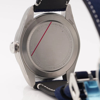 Tudor Geneve Chronometer wristwatch with navy blue dial, bezel and strap, still stickered, on a white background
