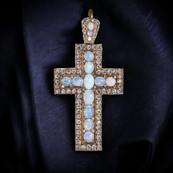 Antique 20 gold cross pendant set with diamonds and opals.
