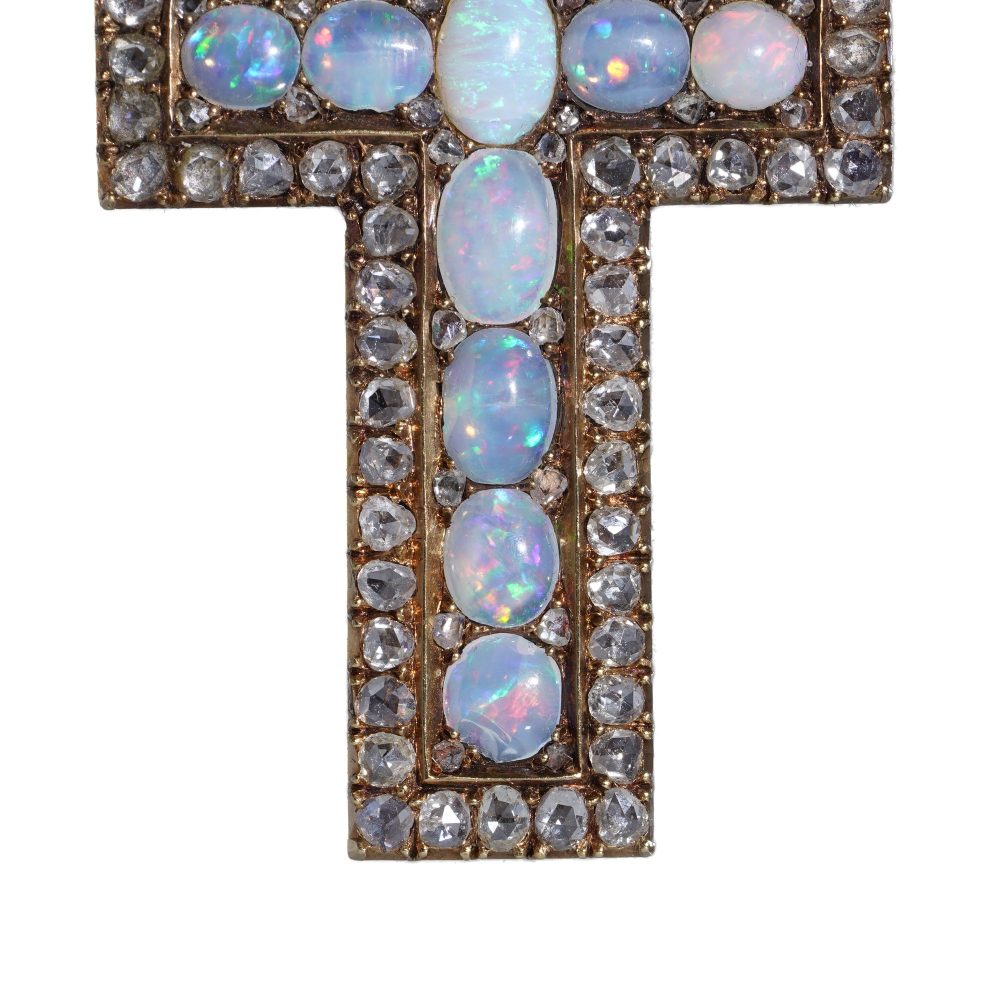 Antique 20 gold cross pendant set with diamonds and opals.