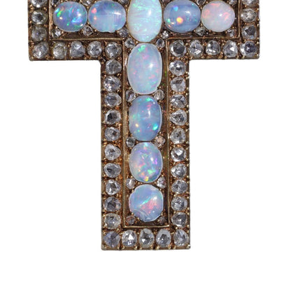 Antique 20 gold cross pendant set with diamonds and opals.