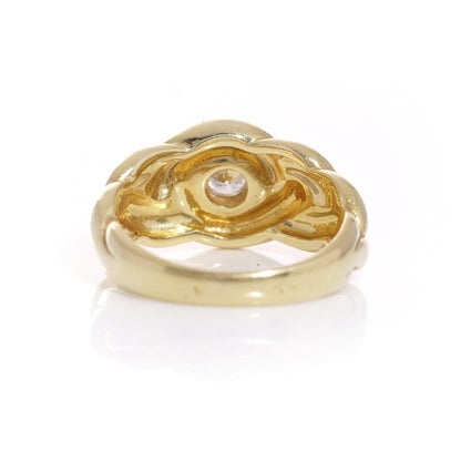 Van Cleef & Arpels gold ring with a diamond at it's heart.