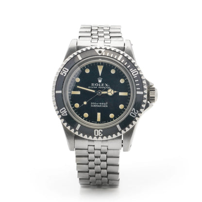 A Rolex Submariner wristwatch in stainless steel with a black dial and jubilee bracelet, on a white background