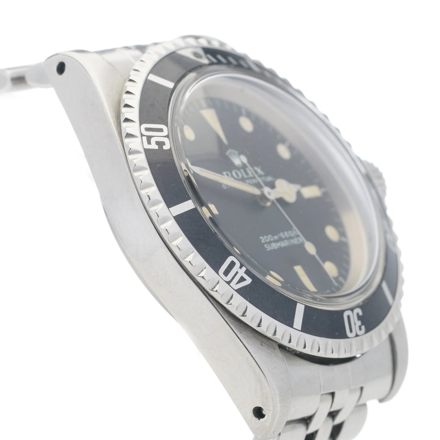 A Rolex Submariner wristwatch in stainless steel with a black dial and jubilee bracelet, on a white background