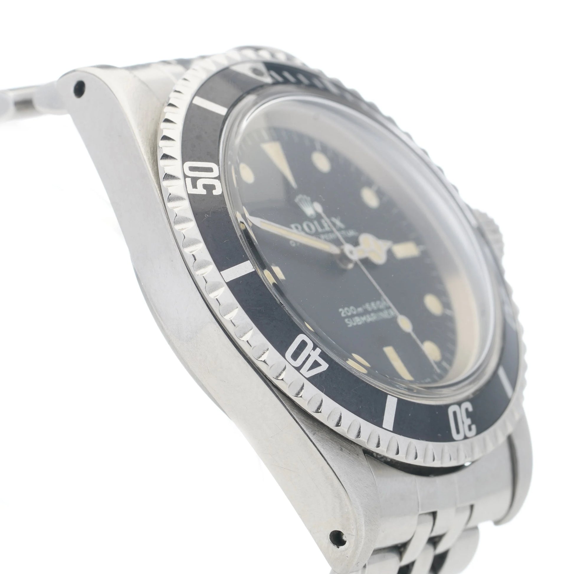 A Rolex Submariner wristwatch in stainless steel with a black dial and jubilee bracelet, on a white background
