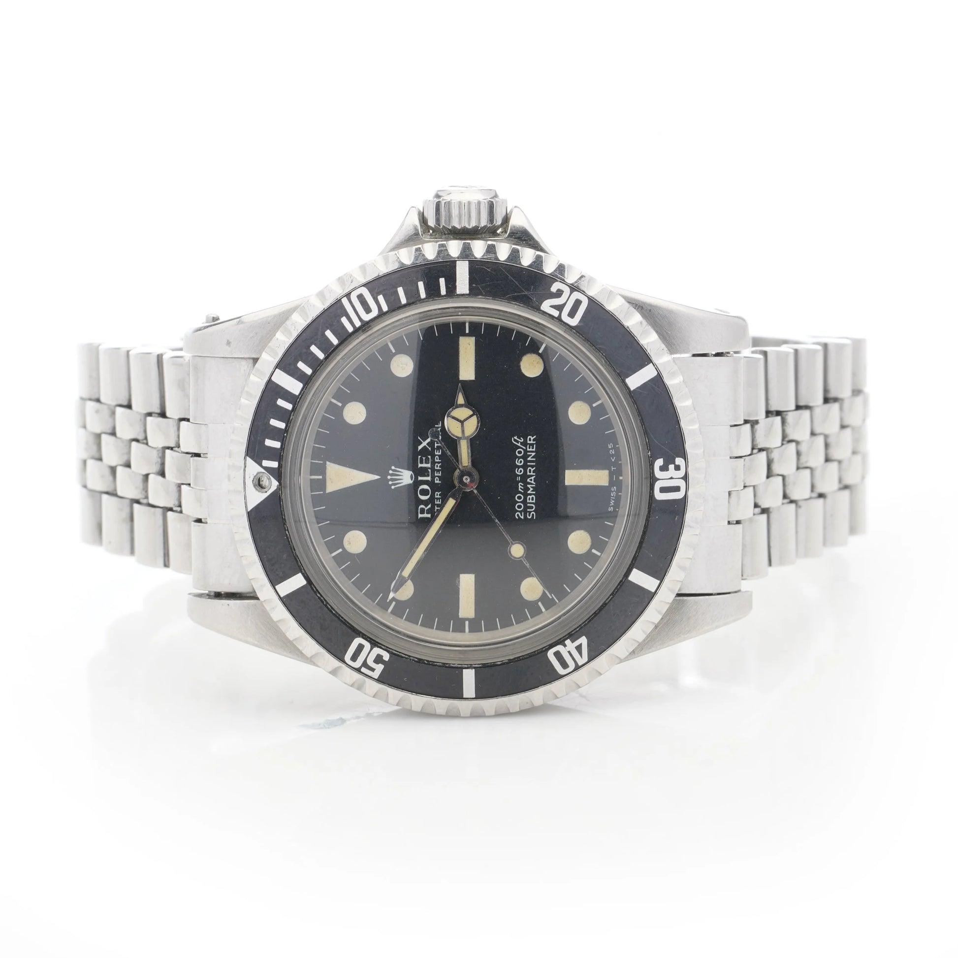 A Rolex Submariner wristwatch in stainless steel with a black dial and jubilee bracelet, on a white background