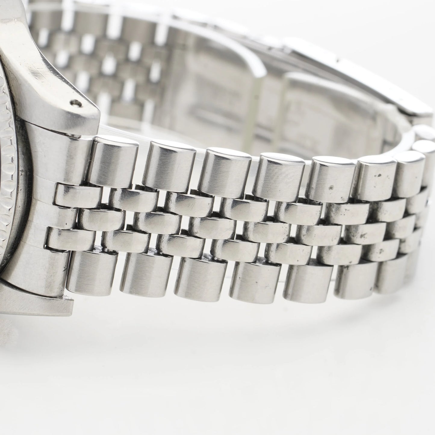 Close-up of a steel jubilee bracelet, on a white background